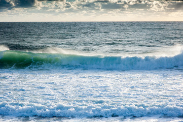 beautiful outdoor seascape during windy stormy sunset with big waves