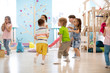 Preschool children run, play educational games in kindergarten or daycare