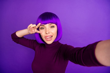 Poster - Coquette lady making self photos sticking tongue out mouth showing v-sign wear trendy clothes isolated purple background