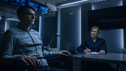 Wall Mural - Female Special Agent Conducts Lie Detector / Polygraph Test on a Young Suspect. Expert Examiner Questions Accused in Interrogation Room. Computer Measures Physiological indices.