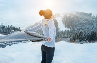 Happy woman traveler on the snowy of mountain look on the nice w