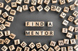 © SecondSide - Find a mentor - phrase from wooden blocks with letters, Online mentorship a voluntary counselor or teacher concept, random letters around, grey background