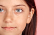 © Viktoriia - Freestyle. Young girl standing isolated on pink smiling relaxed eye close-up