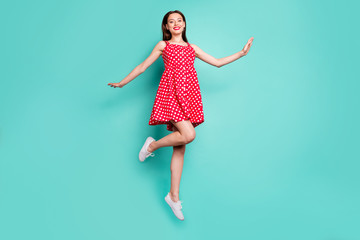 Sticker - Full size photo of lovely girl smiling jumping wearing polka dot skirt dress isolated over teal turquoise background