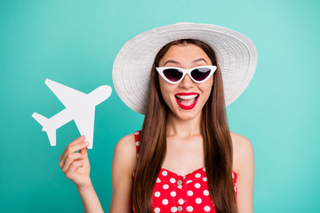 Poster - Close-up portrait of her she nice attractive cheerful cheery positive girlish straight-haired girl holding in hand plane card isolated over green blue turquoise bright vivid shine background