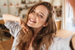 © Drobot Dean - Beautiful happy ginger woman indoors at home take selfie by camera.