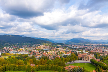 Wall Mural - Picturesque aerial view of Bergamo city, Lombardy, Italy. Bergamo Alps (Alpi Orobie) begin immediately north of the city, on the background