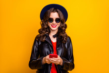 Portrait Of Charming Cheerful Positive Girl Use Her Cellphone Comment Text Blog Post Wear Black Leather Jacket Isolated Yellow Color Background