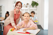 © zinkevych - Beautiful king teacher helping girl with task during the lesson