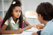 © zinkevych - Cute dark-eyed girl listening to classmate while discussing test