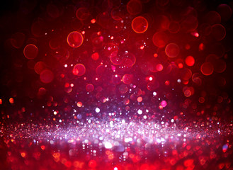 Wall Mural - silver glitter sparkling in red blurred background