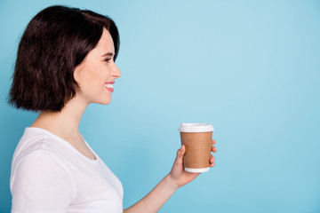 Wall Mural - Close-up profile side view portrait of her she nice-looking attractive lovely winsome cheerful cheery girl holding in hand coffee isolated on bright vivid shine vibrant blue turquoise color background