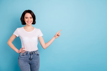 Portrait of her she nice attractive lovely cheerful cheery confident glad girl pointing forefinger aside ad advert copy space isolated on bright vivid shine vibrant blue turquoise color background