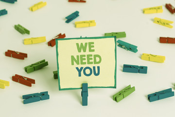 Conceptual hand writing showing We Need You. Concept meaning asking someone to work together for certain job or target Colored clothespin papers empty reminder white floor office