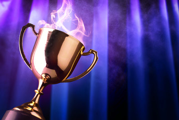 Wall Mural - winner trophy with smoke and background violet light ray on dark blue curtain.