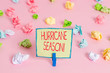 © Zofia - Text sign showing Hurricane Season. Business photo text time when most tropical cyclones are expected to develop Colored crumpled papers empty reminder pink floor background clothespin