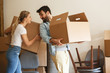 © BalanceFormCreative - Young married couple moving into new home.They unpacking and cleaning .