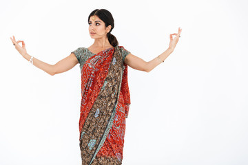 Photo of beautiful hindus girl in traditional indian costume or saree dress and jewelry dancing with gesturing hands