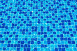 © gjeerawut - Blue ceramic floor in swimming pool with ripple wave water and sun reflection in background concept