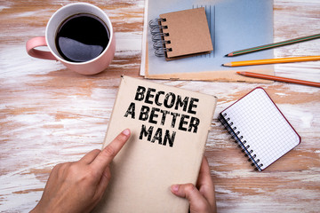 Become a Better Man. Hands holding book on office table