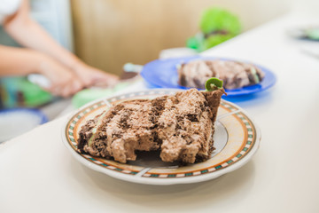 Wall Mural - Chocolate cake piece on plate at birthday party