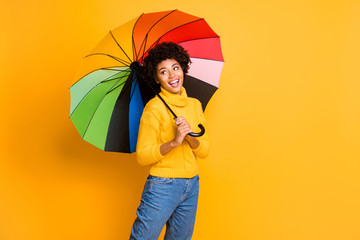 Poster - I like rainy weather concept. Photo of positive cheerful excited emotional singing teenager covering herself with multicolored accessory looking at wet city street having a walk isolated background