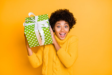 Poster - Close-up portrait of her she nice attractive charming cute lovely cheerful cheery wavy-haired girl holding festal box in hands isolated over bright vivid shine vibrant yellow color background