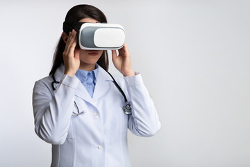 Wall Mural - Lady Doctor Using Virtual Reality Headset In Studio