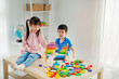 © AUNTYANN - Children playing abacus and wooden block toy in playroom