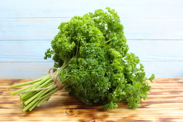 Wall Mural - lush bouquet of fresh parsley lies on the table