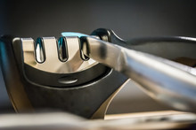 Close-up And Detail Of A Knife In A Knife Sharpener Kitchen Tool. Metal And Chrome. 