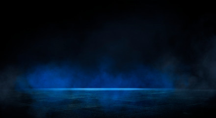blue dark background of empty foggy street with wet asphalt, illuminated by a searchlight, laser bea