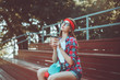 © splitov27 - Young woman skater dressed in stylish clothes sits on the stands in a skatepark and drinks coffee on a bright sunny day