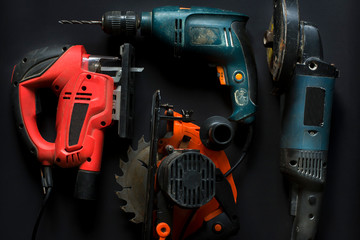 Hand power tools on a black background close-up.