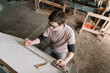 © Alexandr Ivanets/Stocksy - Craftsman making plan at desk