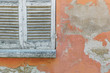 © Duet Postscriptum/Stocksy - Window shutters in weathered house wall