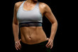 © Yakov - Body of sexy female fitness model on black background