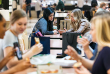 Mall: Women Talking In Busy Food Court