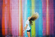 © wendy laurel/Stocksy - teenager girl against brightly colored walls wearing sunglasses on film
