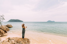Woman Standing On A Rock And Looking At The Beautiful Island