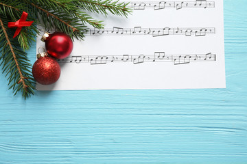 Wall Mural - Flat lay composition with Christmas decorations and music sheet on blue wooden table, space for text