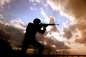 Soldier with machine gun patrolling outdoors. Military service