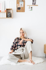 Young woman sitting near collage