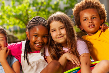 Wall Mural - Close-up portrait of kids group hug and smiling