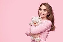 Content teenage girl embracing teddy bear