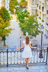 Wall Mural - woman in white dress walking on famous Montmartre hill in Paris