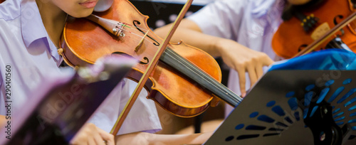 asian-boy-students-playing-violin-with-music-notation-in-the-group-violin-player-violinist-hands-playing-violin-orchestra-musical-instrument-closeup-symphony-orchestra-on-stage-selective-focus