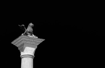 Wall Mural - Saint Mark Lion ancient bronze statue at the top of the medieval column, erected in 1172. Symbol of the old Republic of Venice (Black and White copy space)