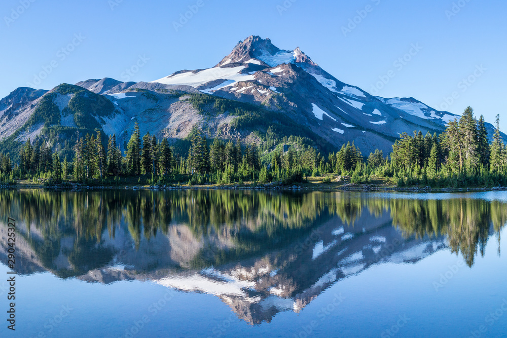 Volcanic mountain in morning light reflected in calm waters of lake.	 - obrazy, fototapety, plakaty 