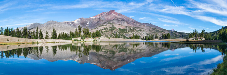 Wall Mural - volcanic mountain in morning light reflected in calm waters of lake.
